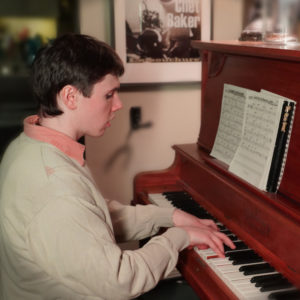 Photo of Liam Newsom, playing piano