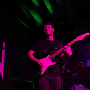 Photo of Spencer Swanson, playing an electric guitar